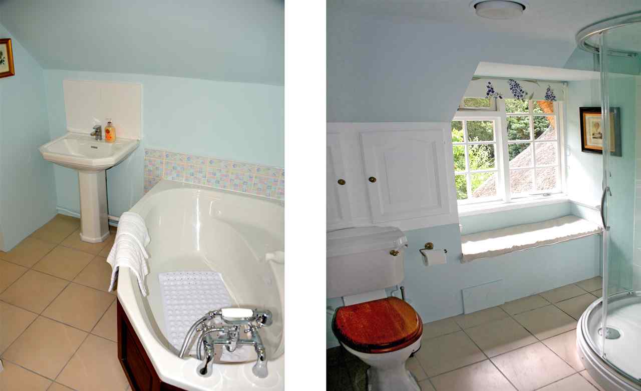 resized-2349823-Beck Cottage family bathroom with corner bath and shower cubicle and window seat overlooking the garden. copy.jpg